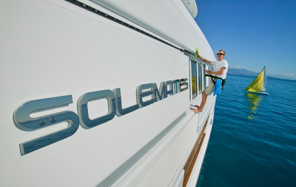 Deckhand Cleaning Yacht Solemates Windows